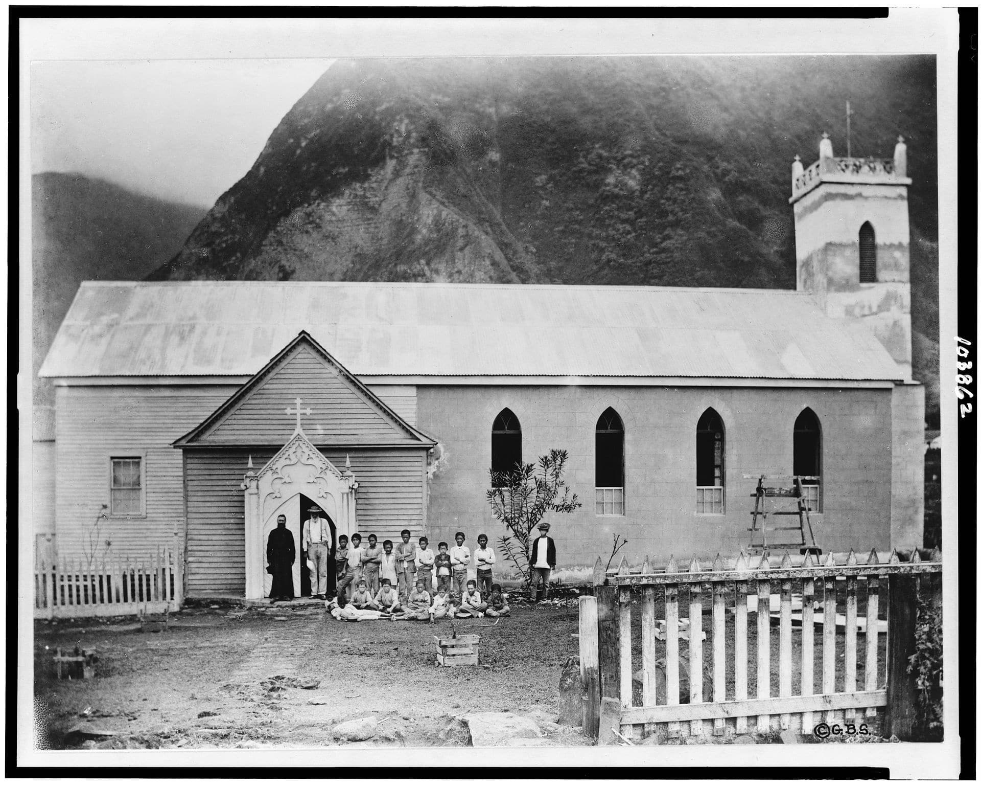 Father Damien with group in front of church