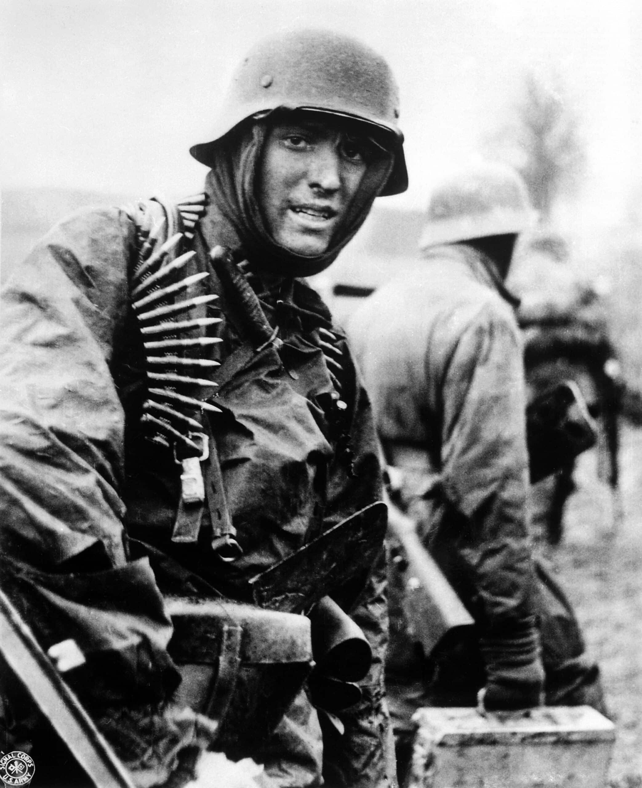 German machine gunner marching through the ardennes in the battle of the bulge